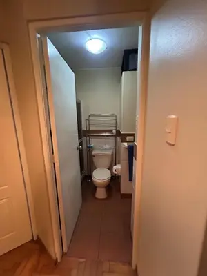 a small bathroom with a toilet in a hallway at Comfort and family exclusivity in Lima