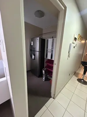 a hallway with a refrigerator in a room at Comfort and family exclusivity in Lima