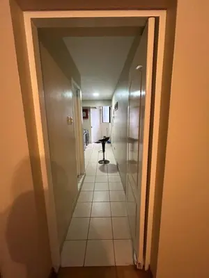 a hallway leading to a bathroom with a tile floor at Comfort and family exclusivity in Lima