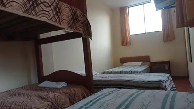 a bedroom with two bunk beds and a window at Hotel Perseo Inn in Barranca