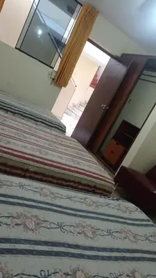 a bed with a large pillow on top of it at Hotel Perseo Inn in Barranca