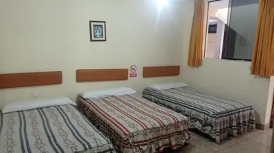 a room with two beds in a room at Hotel Perseo Inn in Barranca