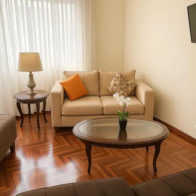 a living room with a couch and a table at Bello departamento en el corazón de Miraflores in Lima