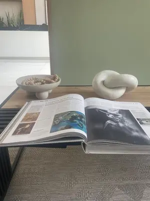 an open book on a table with a bowl of food at Departamento en Magdalena limite con San Isidro in Lima