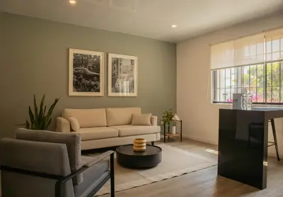 a living room with a couch and a table at Casa la Paz by Wynwood House in Lima