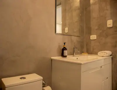a bathroom with a toilet and a sink and a mirror at Casa la Paz by Wynwood House in Lima