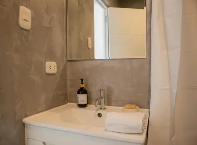 a bathroom with a sink with a bottle of wine on it at Casa la Paz by Wynwood House in Lima