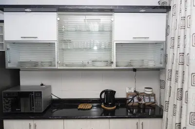 a kitchen with white cabinets and a microwave at Great Location near to everything! in Lima
