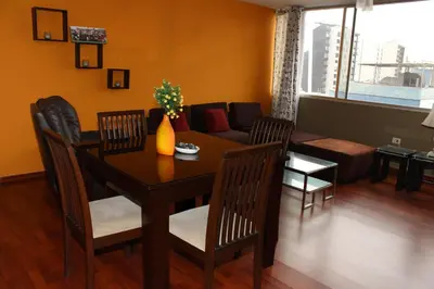 a living room with a table and chairs and a couch at Great Location near to everything! in Lima