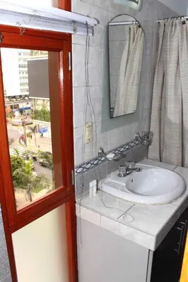 a bathroom with a sink and a mirror at Great Location near to everything! in Lima
