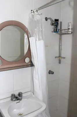 a bathroom with a sink and a shower with a mirror at Great Location near to everything! in Lima