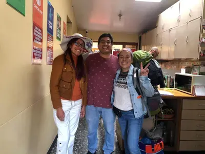 a group of people posing for a picture in a kitchen at Taytacha House in Cusco