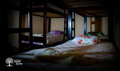two bunk beds in a dark room with at Taytacha House in Cusco