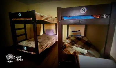 two bunk beds in a small room with a bed at Taytacha House in Cusco