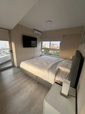 a bedroom with a large bed and a television at Premium apartment with AC Miraflores in Lima