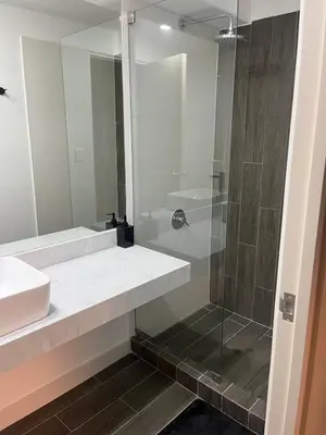 a bathroom with a shower and a sink and a mirror at Premium apartment with AC Miraflores in Lima