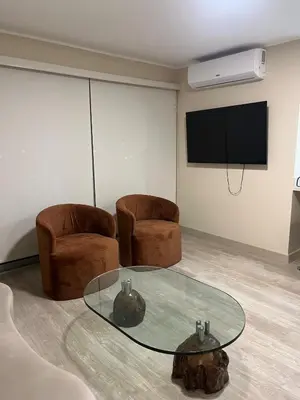 a room with a table and two chairs and a tv at Premium apartment with AC Miraflores in Lima