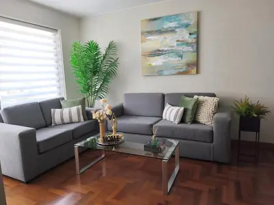 a living room with a couch and a table at Room in shared apartment - Shared Bathroom 402 in Lima