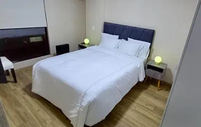 a bedroom with a large white bed with two lamps at Apartment in Miraflores - Lima in Lima