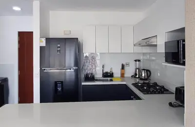 a kitchen with a black refrigerator and a stove at Apartment in Miraflores - Lima in Lima