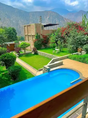 a large blue swimming pool with a view of a garden at Casa de Campo en Santa Eulalia in Santa Eulalia