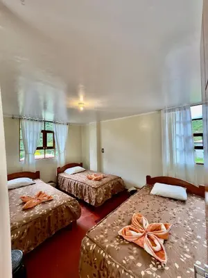 a room with two beds with bows on them at Eco Lodge Elegant Qollpawasi in Colcapampa