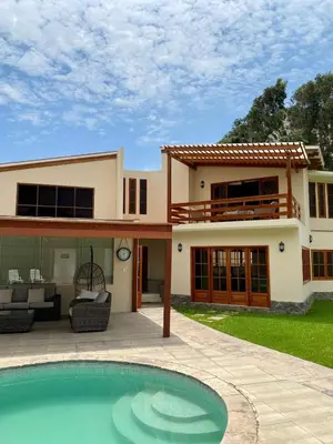 a house with a swimming pool in front of it at Casa Vaí Cieneguilla with a pool in Cieneguilla