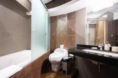 a bathroom with a toilet and a sink at ALU Apartments - Ocean View at Larcomar Miraflores Next to JW Marriott in Lima