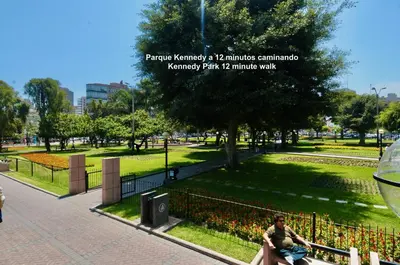 a man sitting on a bench in a park at ALU Apartments - Ocean View at Larcomar Miraflores Next to JW Marriott in Lima