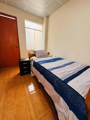 a bedroom with a bed and a window at La CASITA in Cusco
