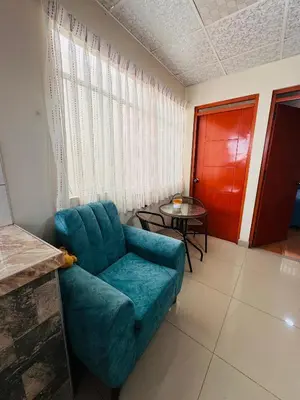 a living room with a blue couch and a table at La CASITA in Cusco