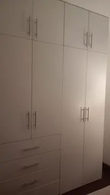 a white closet with white cabinets in a room at Travel & Home Place in Lima
