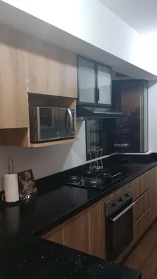 a kitchen with a stove and a microwave at Travel & Home Place in Lima