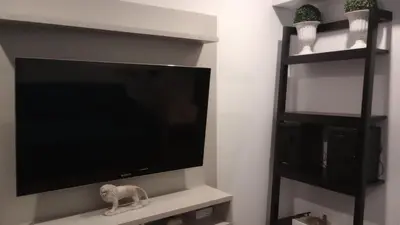 a flat screen tv sitting on a shelf in a living room at Travel & Home Place in Lima
