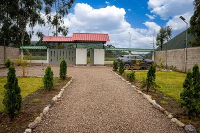 a driveway with a car parked in front of a building at Prana Cabins Oxapampa in Oxapampa