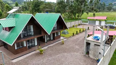 an overhead view of a house with a green roof at Prana Cabins Oxapampa in Oxapampa