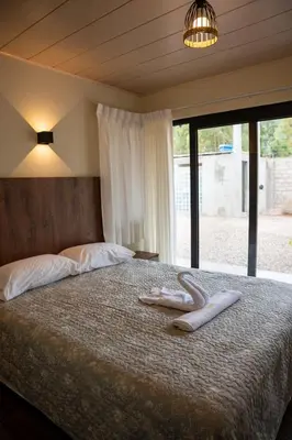 a bedroom with a bed with two towels on it at Prana Cabins Oxapampa in Oxapampa