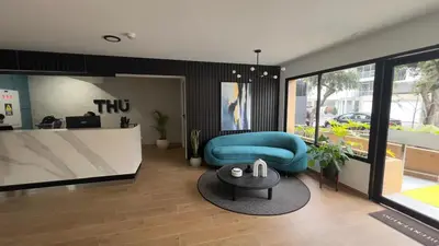a living room with a blue couch and a table at Miraflores Deluxe in Lima