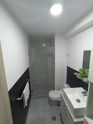 a bathroom with a shower and a toilet and a sink at Refugio de Alexander in Lima