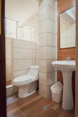 a bathroom with a toilet and a sink at Hotel Casa Suite Inka in Ollantaytambo