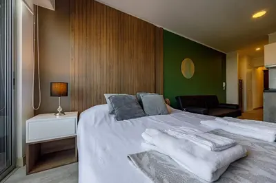a bedroom with a large white bed with towels on it at New apartment in Barranco in Lima