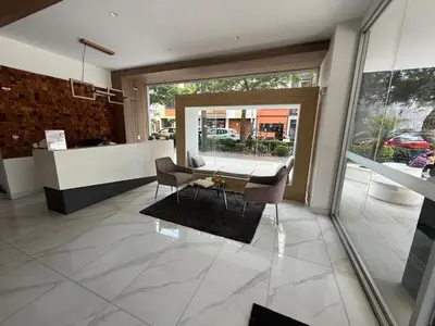 a lobby with a table and chairs in a building at New apartment in Barranco in Lima