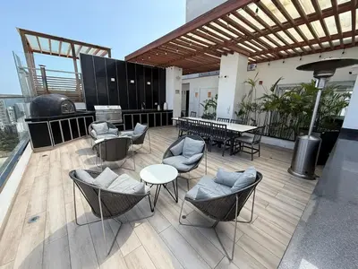 a patio with chairs and a table on a building at New apartment in Barranco in Lima