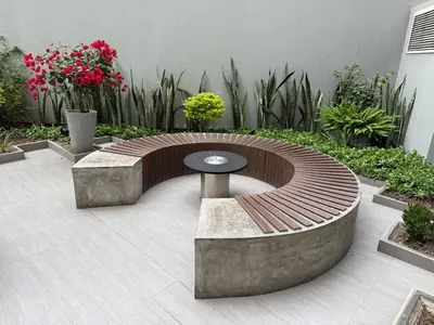 a circular bench and table in a courtyard with flowers at BR1 Barranco Exclusive Department in Lima