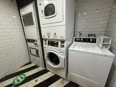 a utility room with a washing machine and a washer at BR1 Barranco Exclusive Department in Lima