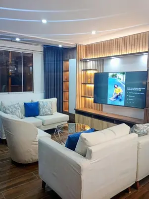 a living room with two couches and a flat screen tv at Apartamento 3D de estreno muy céntrico in Lima