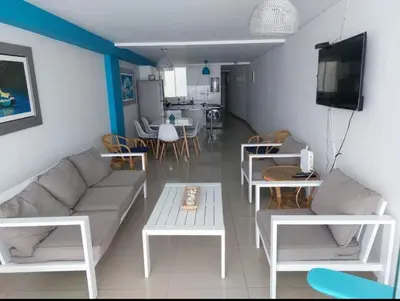 a living room with a couch and a table at Beautiful apartment with an ocean view in San Bartolo