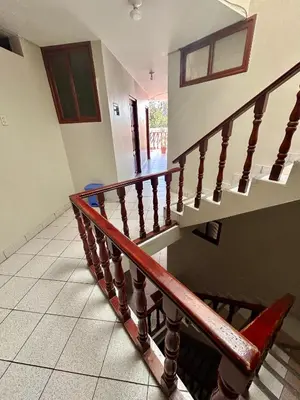 a staircase in a house with a wooden railing at Hs San Cristobal in Ayacucho