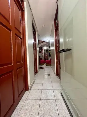 a hallway with a door and a tile floor at Hs San Cristobal in Ayacucho