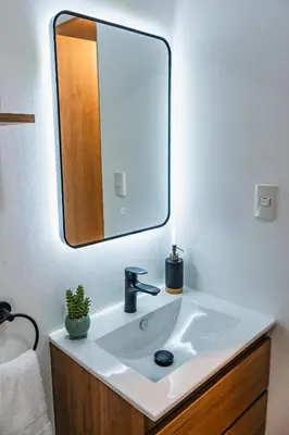 a bathroom with a sink and a mirror at Cozy apartment in Barranco in Lima